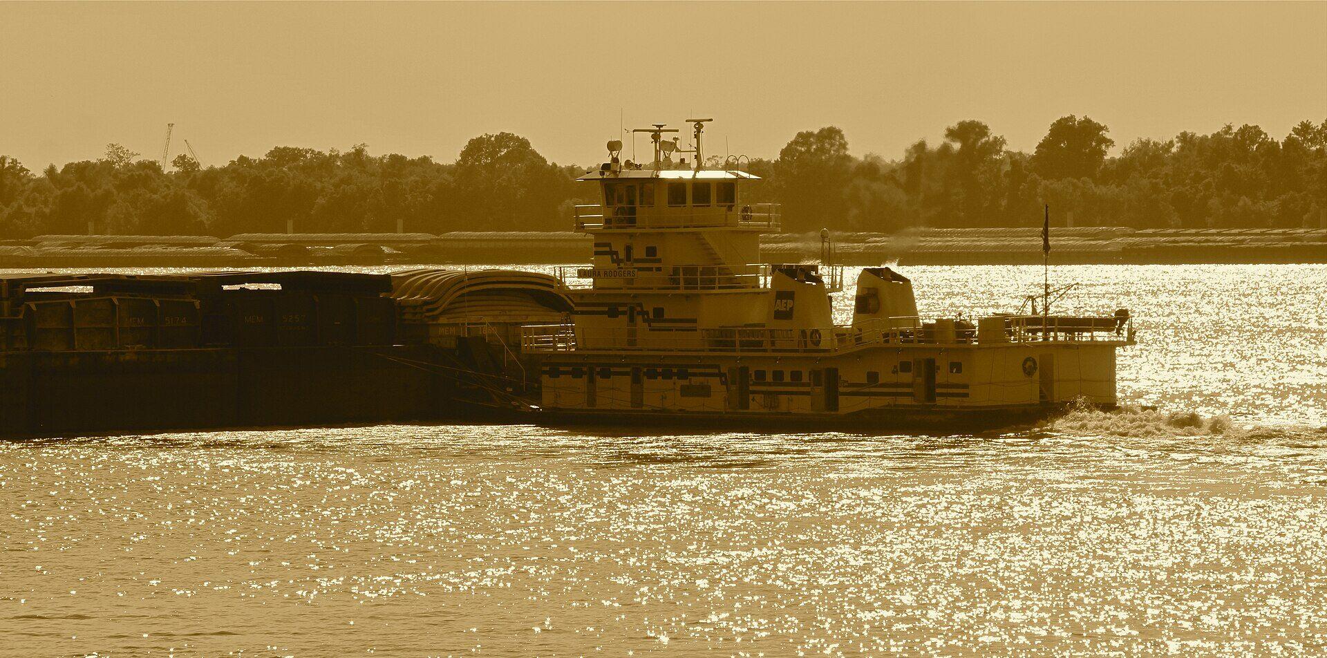 Barges on the Mississippi River at golden hour